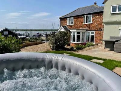 a water slide in front of a house at Cosy Coastal 2-Bedroom Cottage with Hot Tub and Log Burner in West Mersea