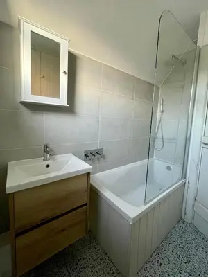 a bathroom with a tub and a sink and a shower at Cosy Coastal 2-Bedroom Cottage with Hot Tub and Log Burner in West Mersea