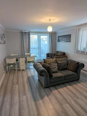 a living room with a couch and a table at A&A Apartment Basildon in Nevendon