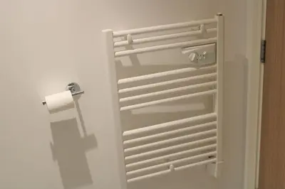 a bathroom door with a roll of toilet paper at Lovely Modern Apartment Close to Town Centre in Lexden