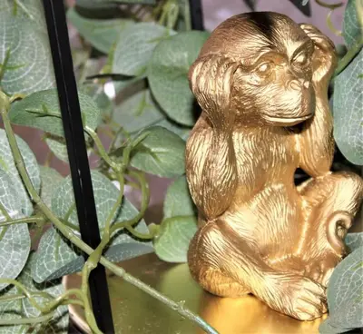 a gold statue of a dog sitting on a table at Lovely Modern Apartment Close to Town Centre in Lexden