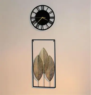 a clock and a mirror with a leaf on a wall at Lovely Modern Apartment Close to Town Centre in Lexden