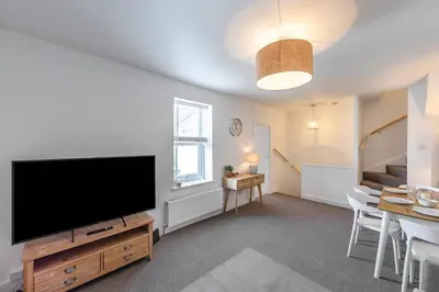 a living room with a large flat screen tv at Sea Breeze Apartment in Walton-on-the-Naze