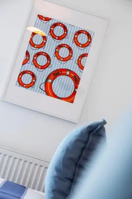 a picture of a sign next to a blue pillow at Sea Breeze Apartment in Walton-on-the-Naze