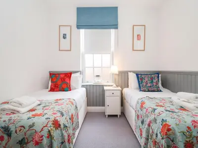 a room with two beds and a window at Ebenezer Chapel in Saxmundham