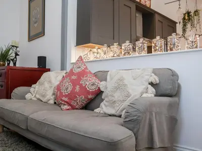 a couch with pillows on it in a living room at Ebenezer Chapel in Saxmundham