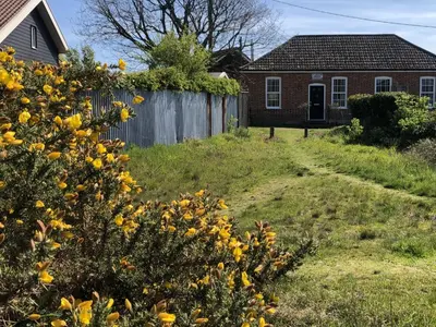 a yard with a fence and a house at Ebenezer Chapel in Saxmundham