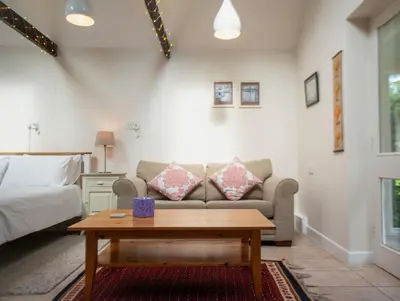 a living room with a couch and a coffee table at The Garden Cottage, Wenhaston, Suffolk, near coast in Halesworth