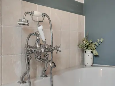 a shower in a bathroom with a bath tub at Hill Farm in Blyford