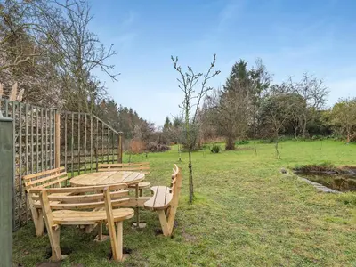 a wooden table and chairs in a field at Hill Farm in Blyford