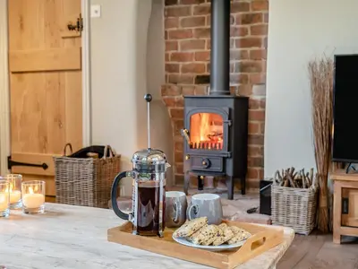 a table with a tray of food and a fireplace at Hill Farm in Blyford