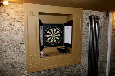 a dart board in a wall with a dartboard at Luxury 9 Bed Manor House Hot Tub Cinema Room SkyTV in Saffron Walden