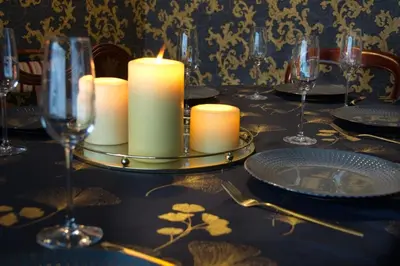 a table with candles and plates and wine glasses at Luxury 9 Bed Manor House Hot Tub Cinema Room SkyTV in Saffron Walden