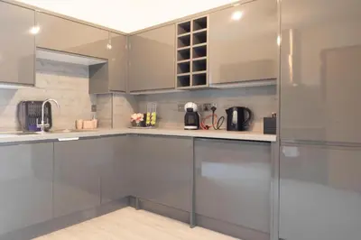 a kitchen with stainless steel cabinets and appliances at Modern Pet-Friendly Apartment in Cambridge with Garden & Parking in Chesterton
