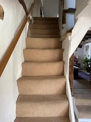 a set of stairs in a house at Acacia Cottage in Halstead