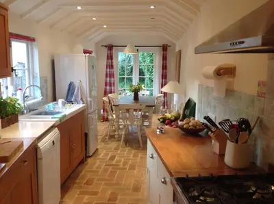 a kitchen with a sink and a counter top at Acacia Cottage in Halstead