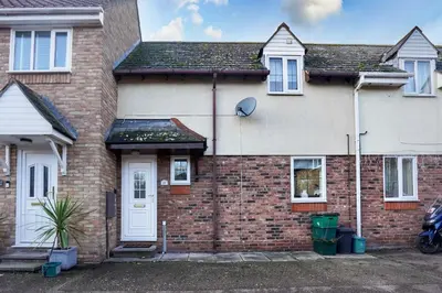 a brick house with a white door at Victoria Gardens in Colchester