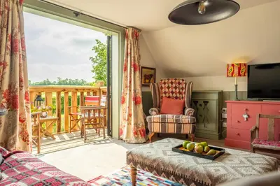 a living room with a view of a deck at Vibrant rural hideaway - Aspen Loft in Sudbury