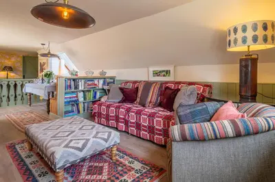 a living room with a couch and a table at Vibrant rural hideaway - Aspen Loft in Sudbury