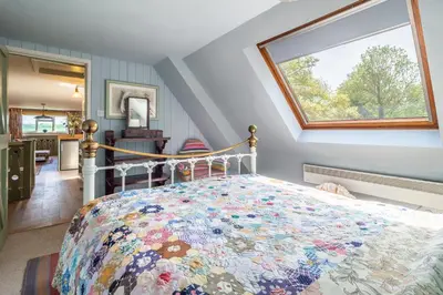 a bedroom with a bed with a quilt on it at Vibrant rural hideaway - Aspen Loft in Sudbury