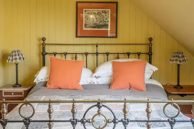a bedroom with a bed with orange pillows at Vibrant rural hideaway - Aspen Loft in Sudbury