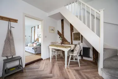 a home office with a desk and stairs at 3 Lower Falkland Cottage Long Melford in Sudbury