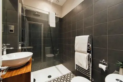 a bathroom with a sink and a toilet and a tub at The Fox at Willian in Letchworth