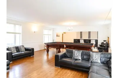 a living room with a pool table and leather couches at 6BD Vacation Home with Indoor Pool in Canvey Island