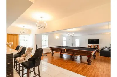 a living room with a pool table in it at 6BD Vacation Home with Indoor Pool in Canvey Island