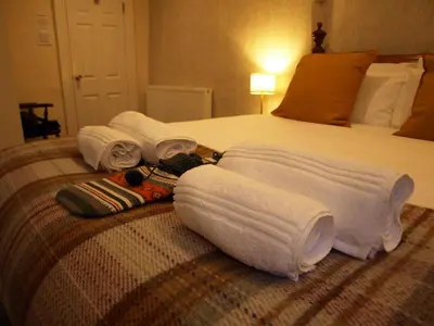 a hotel room with a bed with towels on it at Painters at the Angel in Sudbury