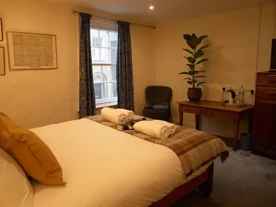 a bedroom with a bed with towels on it at Painters at the Angel in Sudbury
