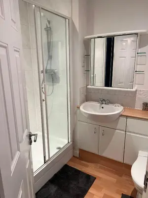 a bathroom with a sink and a shower at Next-Stop Haven in Harlow