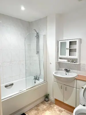 a bathroom with a tub and a sink and a shower at Next-Stop Haven in Harlow