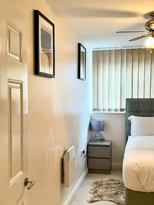 a bedroom with a bed and a window at Next-Stop Haven in Harlow