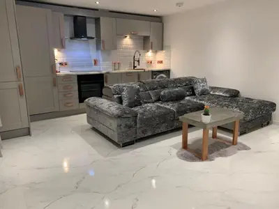 a living room with a couch and a table at Bury St Edmunds - Apartment - Sleeps 2 - Parking in Bury Saint Edmunds