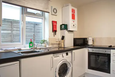 a kitchen with a sink and a washing machine at Host & Stay - Clacton Coastal Hideaway in Clacton-on-Sea