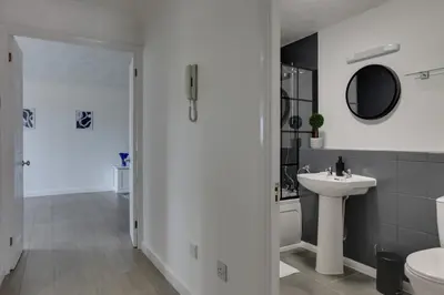 a bathroom with a sink and a toilet and a mirror at Entire home/flat perfect for contractors in Bishops Stortford