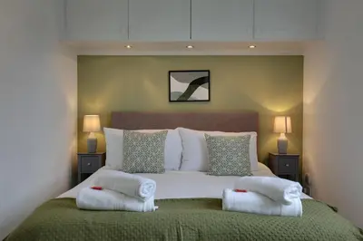 a bedroom with a large bed with two pillows on it at Entire home/flat perfect for contractors in Bishops Stortford