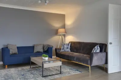 a living room with a couch and a table at Entire home/flat perfect for contractors in Bishops Stortford