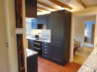 a kitchen with blue cabinets and a counter top at Beautifully appointed & cosy self contained annexe in Walsham le Willows