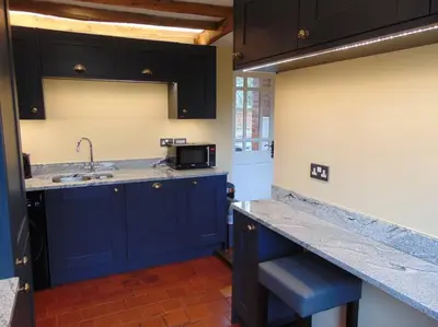 a kitchen with blue cabinets and a sink at Beautifully appointed & cosy self contained annexe in Walsham le Willows
