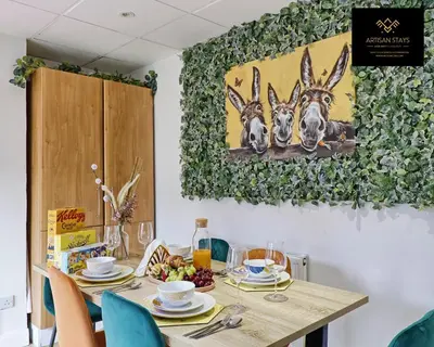 a table with plates of food on it at Spacious 3 Bedroom and 2 Bathroom in Southend-on-Sea By Artisan Stays I Weekly or Monthly Stay Offer I Free Parking I Sleeps 7 in Southend-on-Sea