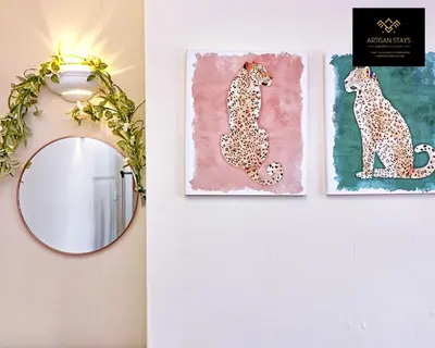 a mirror and a painting of a leopard on a wall at Spacious 3 Bedroom and 2 Bathroom in Southend-on-Sea By Artisan Stays I Weekly or Monthly Stay Offer I Free Parking I Sleeps 7 in Southend-on-Sea