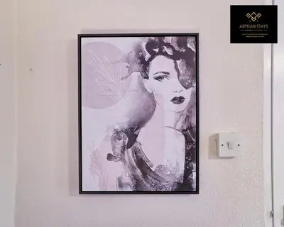 a picture of a woman hanging on a wall at Spacious 3 Bedroom and 2 Bathroom in Southend-on-Sea By Artisan Stays I Weekly or Monthly Stay Offer I Free Parking I Sleeps 7 in Southend-on-Sea