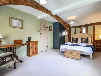 a bedroom with a bed with a wooden frame at The Bridewell in Woodbridge