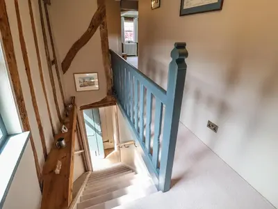 a staircase in a house with a blue railing at The Bridewell in Woodbridge