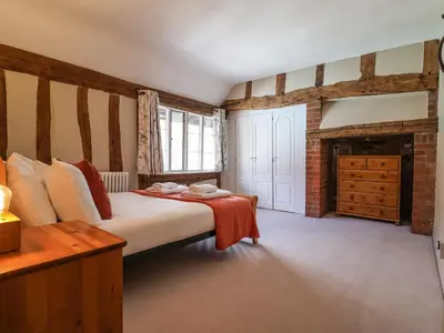 a bedroom with a bed and a fireplace at The Bridewell in Woodbridge