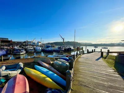 a bunch of boats parked next to a dock at The Bridewell in Woodbridge