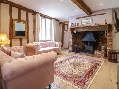 a living room with two couches and a fireplace at The Bridewell in Woodbridge