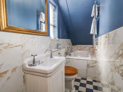 a bathroom with a sink and a toilet and a mirror at The Bridewell in Woodbridge